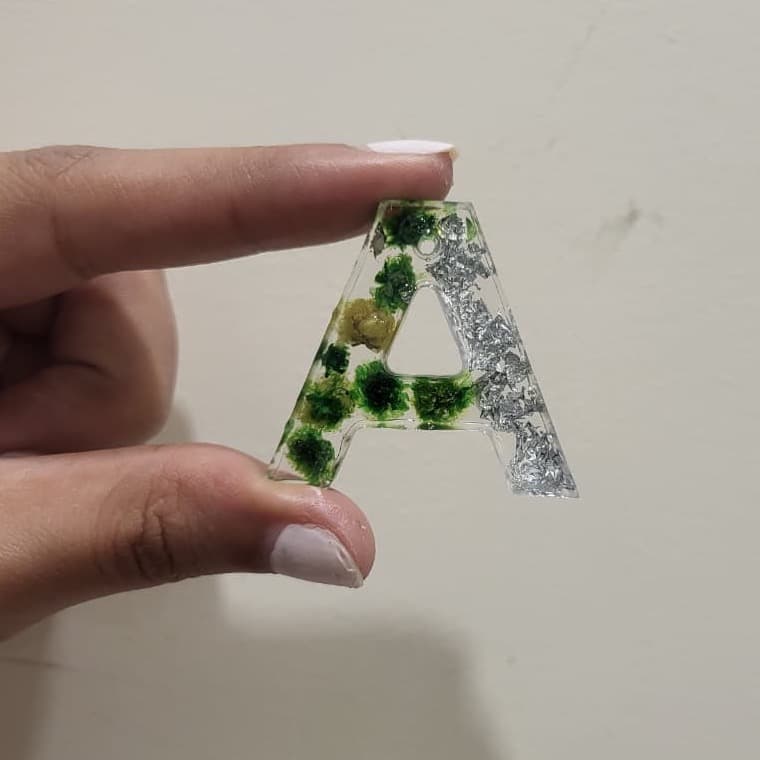 A freshly demoulded letter A with green blooms and silver leaf